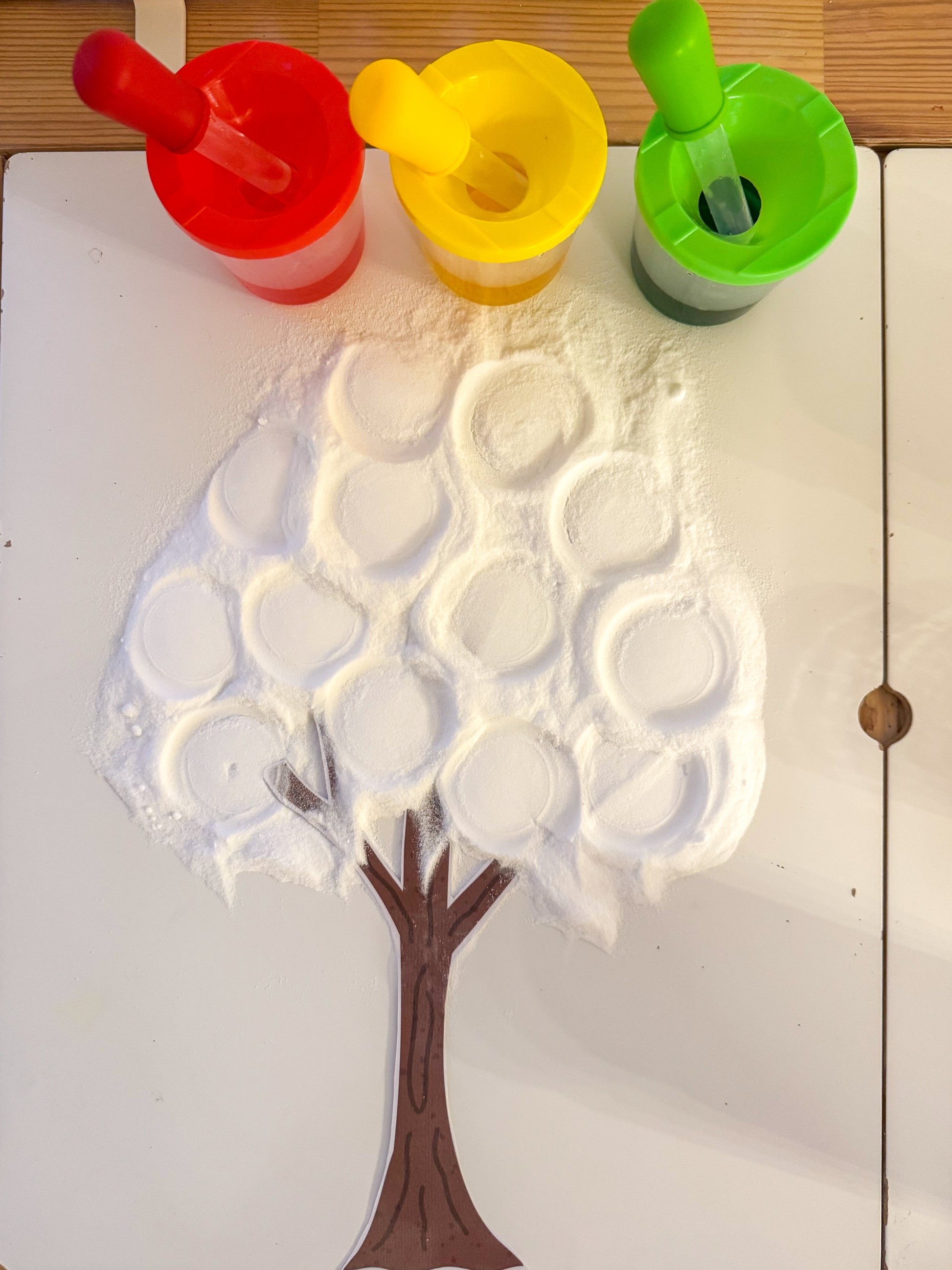 Tree-shaped mold with foam bubbles on a white surface
